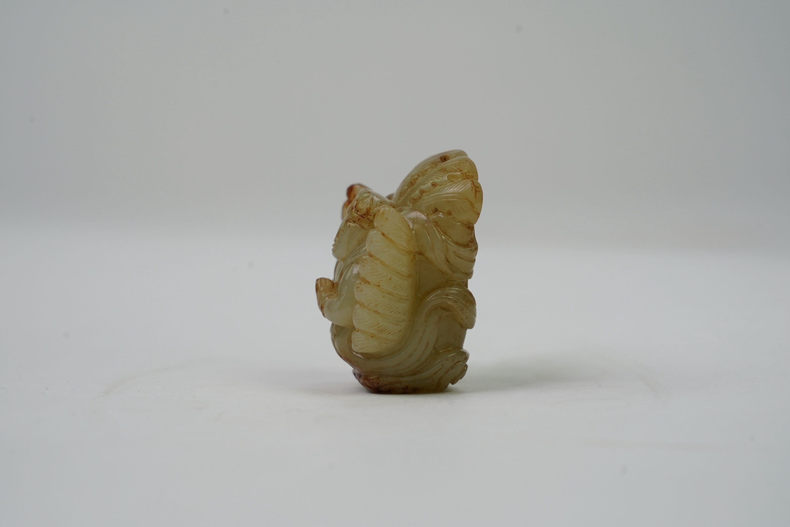 A Chinese archaistic celadon and russet jade figure a winged female immortal bird